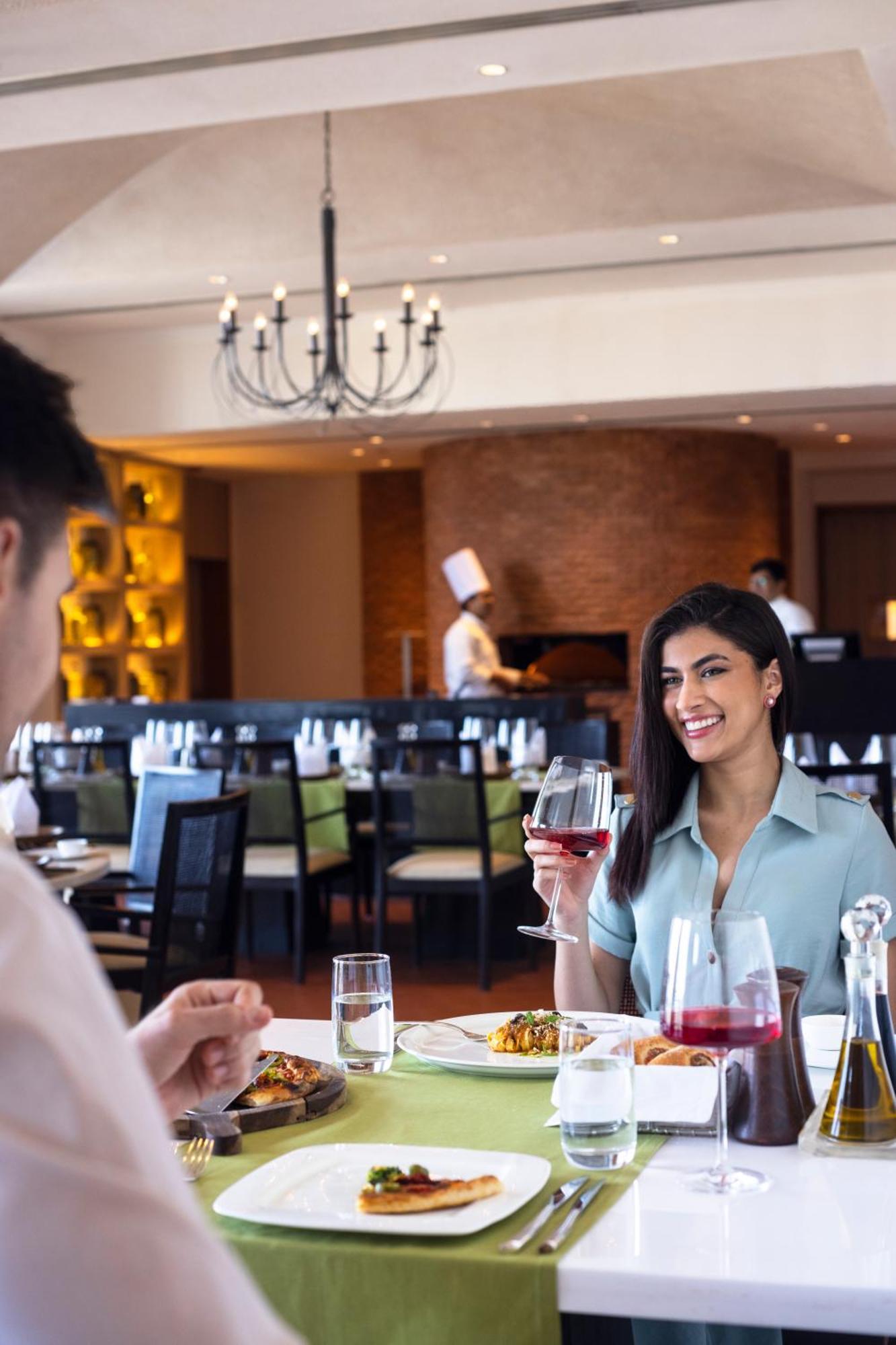 Trident Hyderabad Hotell Exteriör bild A woman drinking wine